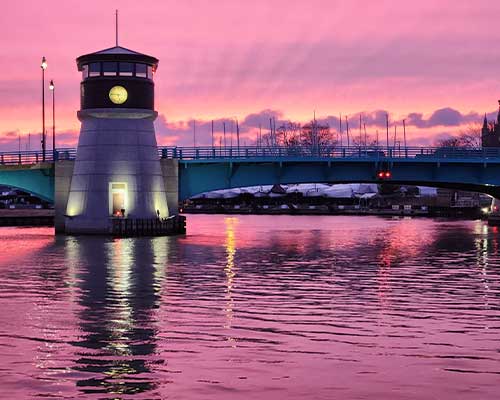 Enjoy beautiful sunsets behind the lighthouse at River's End Restaurants in Racine WI.